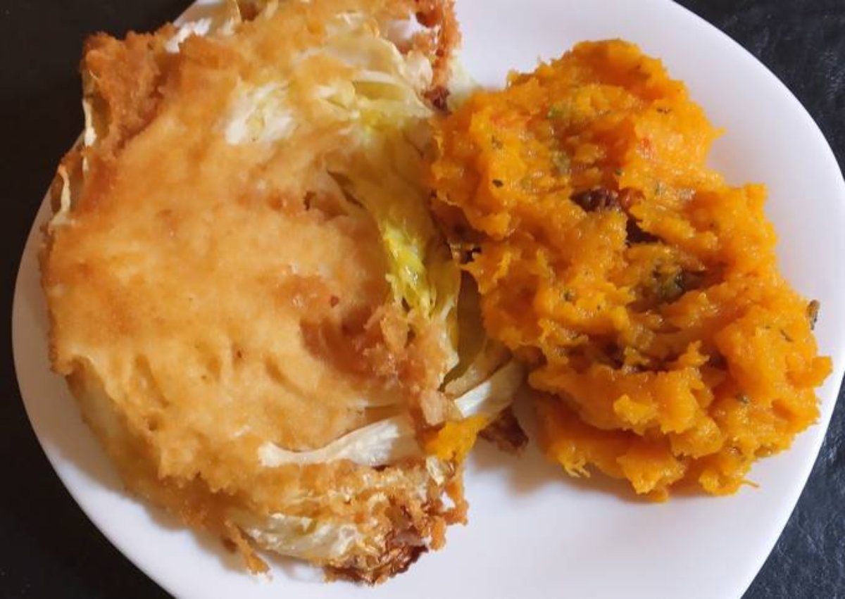 Milanesa de repollo con puré de calabaza, espinacas y pasas